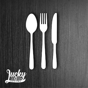 May include: A white silhouette of a fork, knife, and spoon against a dark wood background.