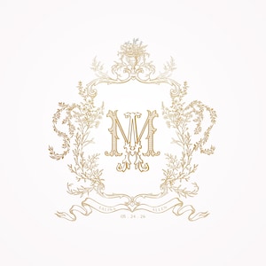 May include: A gold monogram with the letters "M" and "M" intertwined, surrounded by a decorative floral wreath. The wreath is topped with a vase of flowers. A ribbon at the bottom reads "Salina Allen 06.24.26".