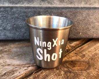 1 oz. stainless steel shot cup with white waterproof decal wording “NingXia Shot”