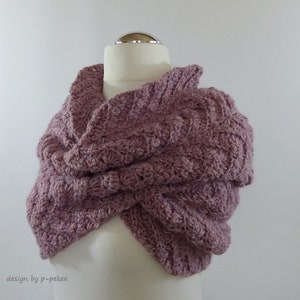 May include: A mauve crocheted cowl or scarf draped over a white mannequin. The cowl is made with a textured stitch pattern.