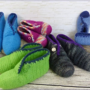 May include: Six pairs of crocheted slippers in various colors, including green, blue, purple, and pink. The slippers have a button detail and are made with a soft, textured yarn.