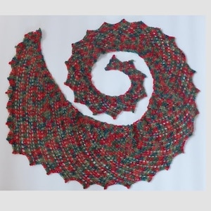 Könnte beinhalten: Ein rot, grün und blauer gehäkelter Schal mit einem gewellten Rand. Der Schal ist spiralförmig gefaltet.