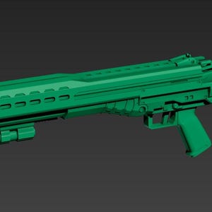 May include: A green, futuristic-looking rifle with a long barrel and a stock. The rifle has a series of vents along the top and a grip for holding. The overall design suggests a high-tech or science fiction theme.