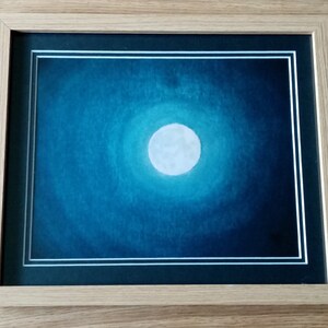 May include: A framed painting depicting a full moon in a dark blue sky. The moon is white and appears to be glowing.