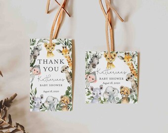 May include: Two thank you tags with a jungle animal theme. The tags are white with green leaves and feature a variety of animals including a giraffe, lion, zebra, monkey, elephant, and rhino. The text on the tags reads "Thank You Katherine's Baby Shower August 18, 2020".