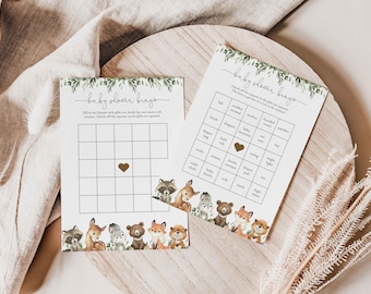 May include: Two printable baby shower bingo cards with a woodland theme. The cards feature a grid with squares to check off as gifts are opened. The cards are decorated with a border of woodland animals, including a raccoon, deer, fox, and bear.