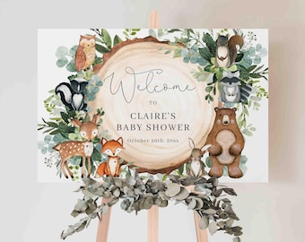 May include: A baby shower welcome sign featuring woodland animals like a deer, fox, and bear. The sign has a watercolor design with the text "Welcome to Claire's Baby Shower" and the date October 20th, 20xx.