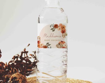 May include: Water bottle label with a fall-themed design featuring pumpkins, leaves, and flowers in shades of orange, brown, and white. The label reads "Maddison's Baby Shower".