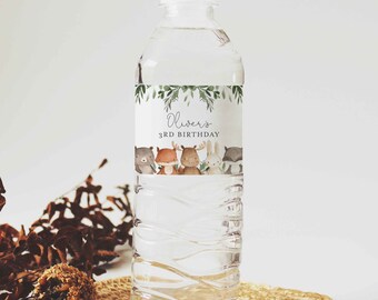 May include: A clear plastic water bottle with a white cap. The label features a green leaf border and the text "Oliver's 3rd Birthday." Below the text are illustrations of a bear, fox, moose, rabbit, and raccoon.