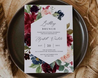 May include: A white invitation card with a floral design featuring burgundy, pink, and blue flowers. The text on the card reads "Birthday Brunch", "Please join us as we celebrate the 30th birthday of Elizabeth Winslet", "Sat | 20 | Dec", "The Blushed Oak", "144 N County Rd, Palm Beach, FL33480", "RSVP by September 15th", "987-000-3456".