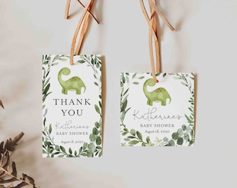 May include: Two green and white baby shower favor tags with a green dinosaur illustration and the text "Thank You" and "Katherine's Baby Shower August 18, 2020".