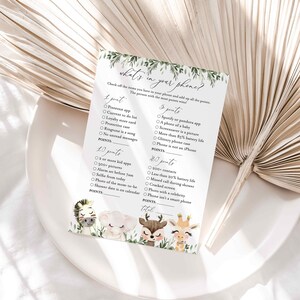 May include: A printable game card with a green leafy border and cute animal illustrations. The card has a title "What's in your phone?" and lists various items to check off on your phone for points. The person with the most points wins.