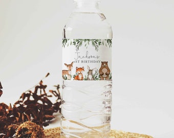 May include: Water bottle label with a woodland theme. The label features a deer, fox, rabbit, and bear with green leaves and the text "Jackson's 1st Birthday".