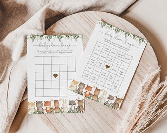 May include: Two printable baby shower bingo cards with a woodland animal theme. The cards feature a grid with squares to check off as gifts are opened. The text on the cards reads "baby shower bingo".