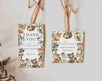 May include: Two thank you tags with a woodland animal theme. The tags are white with green foliage and feature various woodland animals, including a fox, owl, raccoon, bear, and deer. The text on the tags reads "Thank You Katherine's Baby Shower August 18, 2020".
