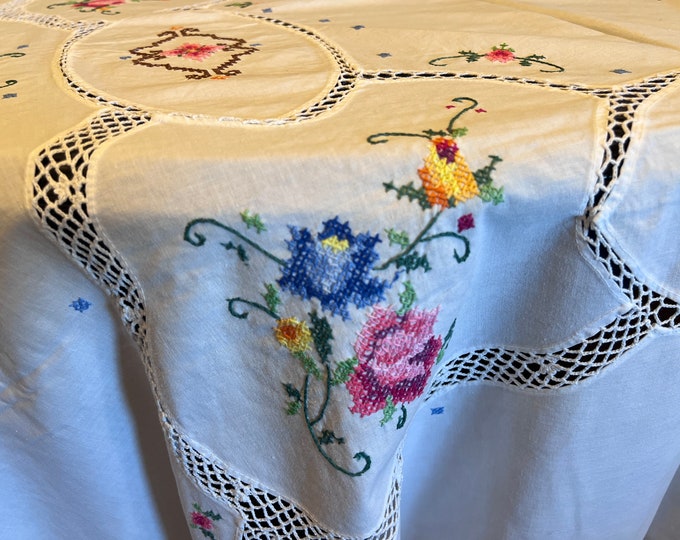 Luxurious cotton tablecloth with handmade cross-stitch embroidery and lace.
