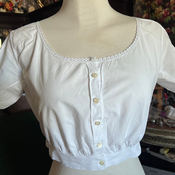 French lingerie. Underblouse from the beginning of the last century. Women's cotton bodice with lace. Antique bodice.