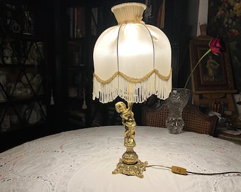 Antique bronze cherub table lamp with a beautiful fabric lampshade