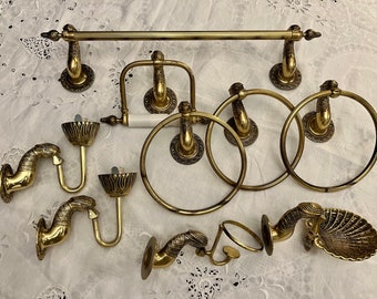 The Brass Bird bathroom accessories set consists of 9 pieces. Vintage plumbing