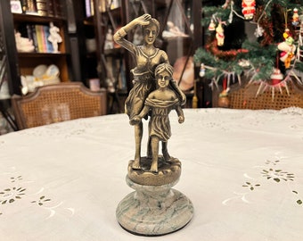 Antique bronze figurine on a marble pedestal. Mother and daughter.