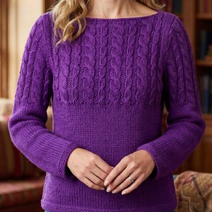 May include: A vibrant purple long-sleeve jumper featuring a textured cable knit pattern across the upper chest and shoulders, transitioning into a smooth stockinette stitch on the lower body and sleeves, finished with a simple boat neckline.