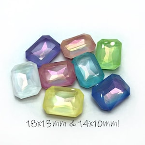 May include: Assortment of iridescent, faceted, rectangular gem-shaped embellishments in various pastel colors, including light blue, pink, green, yellow, and purple. The gems are approximately 18mm x 13mm and 14mm x 10mm.