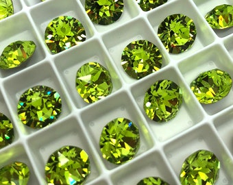 May include: A collection of bright green, faceted gemstones, likely peridot, arranged in a white grid. The gems have a brilliant cut, reflecting light and showcasing their vibrant color. The arrangement suggests they are for jewelry making.