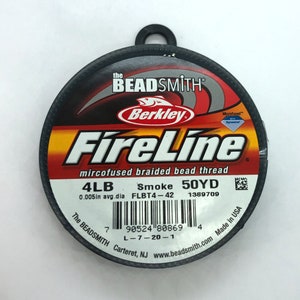 May include: A spool of Berkley FireLine microfused braided bead thread in smoke color. The spool is 50 yards long and 4lb test. The label also includes the text "The Beadsmith" and "Made in USA".