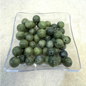 May include: A handmade wooden sign with the text "Welcome" in a playful font. The sign is painted white with a distressed finish, and features a decorative floral design in shades of pink and green. It is designed for indoor or outdoor use.