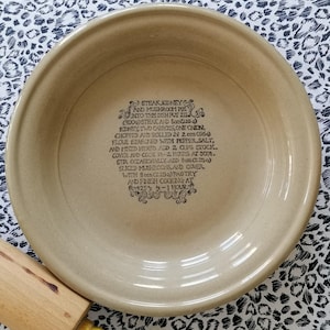 May include: A beige ceramic pie dish with a recipe for Steak, Kidney and Mushroom Pie printed on the bottom. The recipe includes ingredients and cooking instructions.