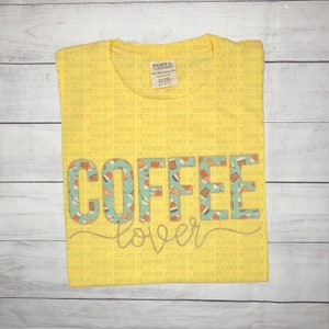 May include: Yellow t-shirt with a coffee cup design and the text "COFFEE lover" printed on it.