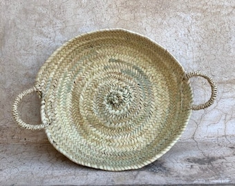Round handle basket made of woven palm leaves