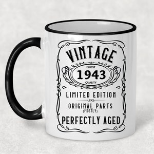 May include: White ceramic mug with a black handle and black rim. The mug has a vintage design with the text "Vintage Finest 1943 Quality Limited Edition Original Parts (Mostly) Perfectly Aged".