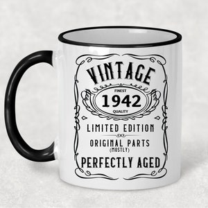 May include: White ceramic mug with a black handle and black rim. The mug has a vintage design with the text "Vintage Finest 1942 Quality Limited Edition Original Parts (Mostly) Perfectly Aged".