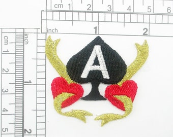 May include: Embroidered iron-on patch featuring a black spade with a white "A" inside, surrounded by two red and gold hearts with gold ribbon tails.