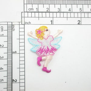 May include: Embroidered iron-on patch of a pink and blue fairy with wings, a yellow flower in her hair, and pink shoes.