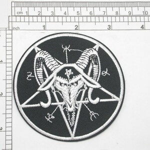 May include: A black and white embroidered patch featuring a pentagram with a goat's head inside. The goat's head has horns and a skull with a star in the center. The patch is circular and has a white border.