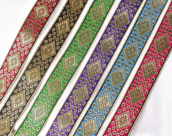 May include: Six different colors of trim with a gold and black geometric pattern. The trim is made of fabric and has a shiny gold thread woven into the design.