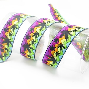 May include: A colorful elastic ribbon with a repeating pattern of black palm trees on a wavy background of green, yellow, orange, purple, and blue.