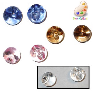 May include: A collection of round buttons in various colors, including blue, gold, pink, and silver. The buttons have a unique design with a central post and decorative elements. The image also includes a color palette icon with the text "Color Options."
