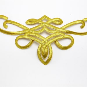 May include: Gold embroidered decorative trim with a swirling, intricate design. This trim is perfect for adding a touch of elegance to clothing, crafts, and home decor projects.