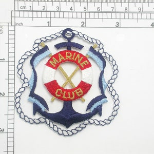 May include: Embroidered patch with a blue anchor, red and white life preserver, and the words "MARINE CLUB" in gold. The patch is surrounded by a white rope design.