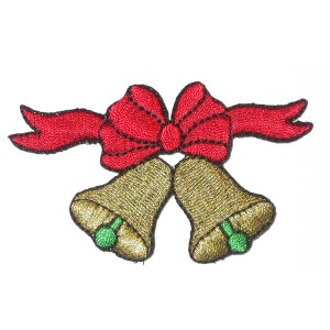 May include: Two gold bells tied together with a red ribbon and bow. The bells have green accents.