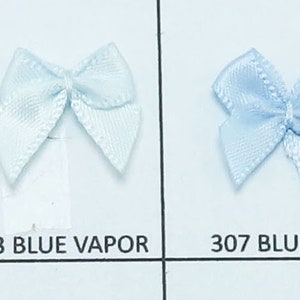 May include: A collection of ten small satin ribbon bows in various colors, including hot red, wine, plum, blue vapor, bluebell, aqua, bluebird, and capri blue. Each bow is approximately 1.5 inches wide.