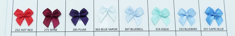 May include: A collection of ten small satin ribbon bows in various colors, including hot red, wine, plum, blue vapor, bluebell, aqua, bluebird, and capri blue. Each bow is approximately 1.5 inches wide.