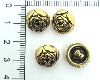 May include: Four gold-toned metal buttons with a rose design. The buttons are approximately 1 inch in diameter.