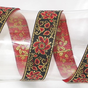 May include: Red and gold floral trim with a black background. The trim is woven with a repeating pattern of flowers and leaves.