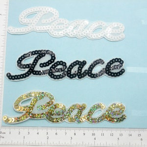 Sequin Peace Word Iron On Applique - White Gold Black 5 1/4&quot; x 1 3/8&quot;