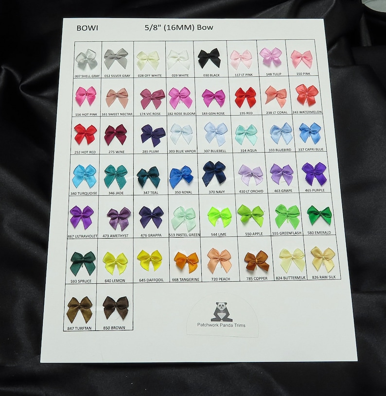 May include: A chart of 5/8 inch (16 mm) satin ribbon bows in a variety of colors. The chart is labeled "BOWI 5/8" (16MM) Bow" and includes the color name and number for each bow.
