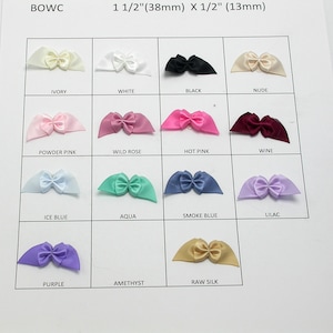 May include: A chart showing 14 different colors of 1 1/2 inch by 1/2 inch satin ribbon bows. The colors are ivory, white, black, nude, powder pink, wild rose, hot pink, wine, ice blue, aqua, smoke blue, lilac, purple, amethyst, and raw silk.
